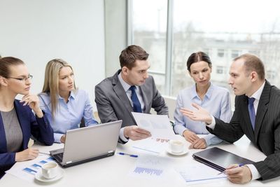 business team with laptop having discussion