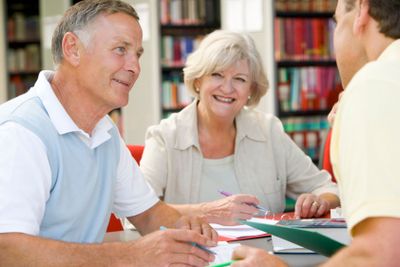 Adult students working together in a library