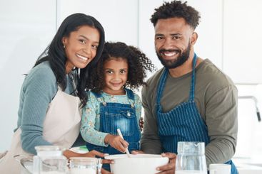 Parents, child and baking portrait in home with bonding...