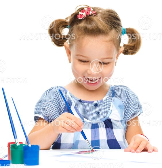 Little girl is painting with gouache