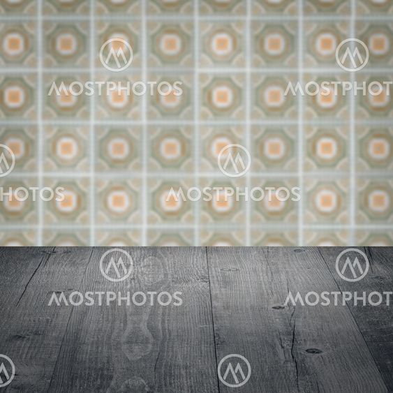 Wood table top and blur vintage ceramic tile pattern wall