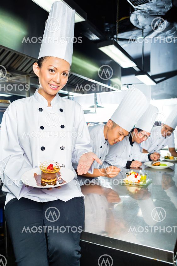Asian Chef in restaurant kitchen cooking