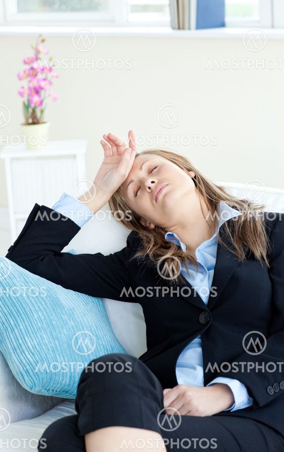 Stressed businesswoman slepping on a sofa
