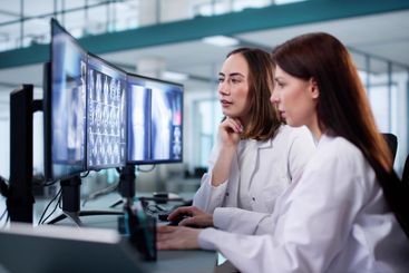 Female Dentist Examining Xray Images of Patient's Teeth