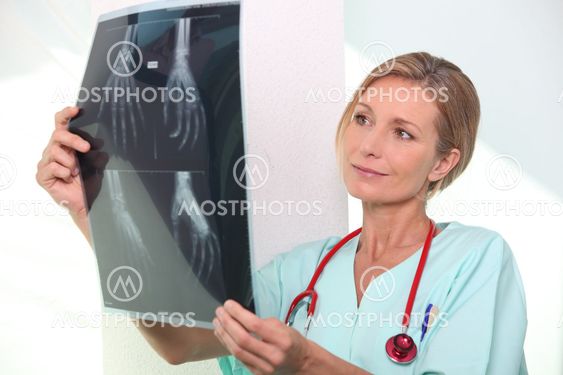 Nurse looking at X-ray