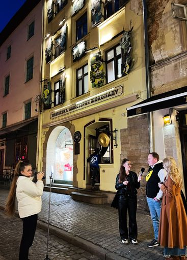 Evening interview in front of an illuminated historic...