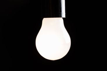 Close-up of electrical bulb on black background