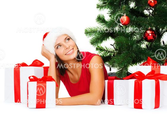 smiling woman in santa helper hat with gift boxes