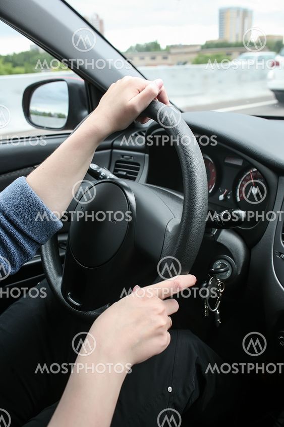 Female hands on wheel