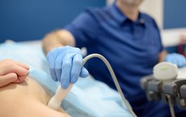 Mammologist doctor examines a woman breasts and lymph...