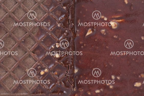 Close up chocolate-coated ice cream sandwich.