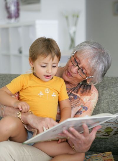 Woman reading with her grandson