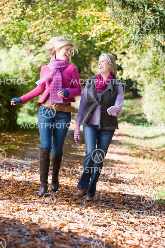 Mother and daughter on walk through woods