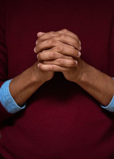 Faith, hands and prayer with Christian person closeup at...