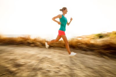 Young woman on her evening jog along the seacoast 