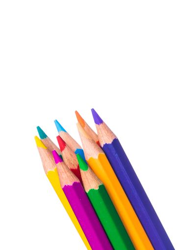 Vibrant colored pencils clustered together on a plain...