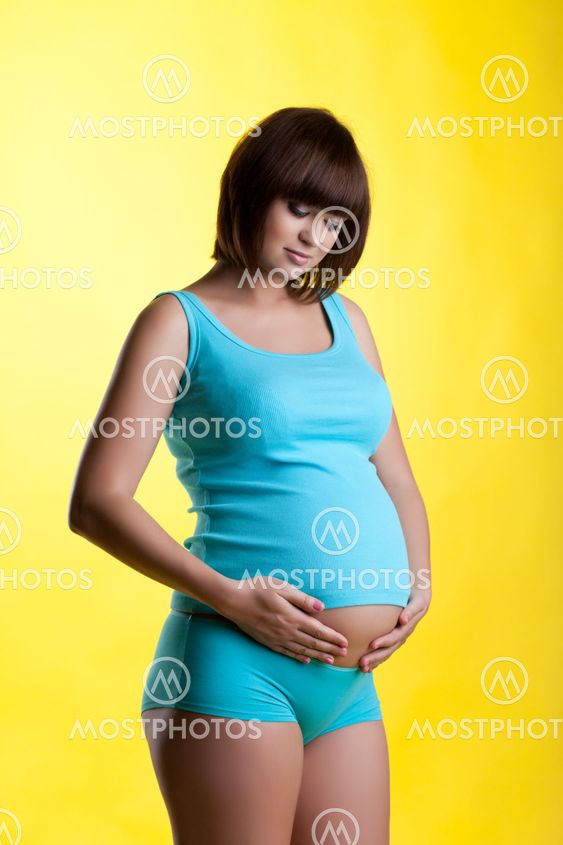 Pretty pregnant brunette young woman