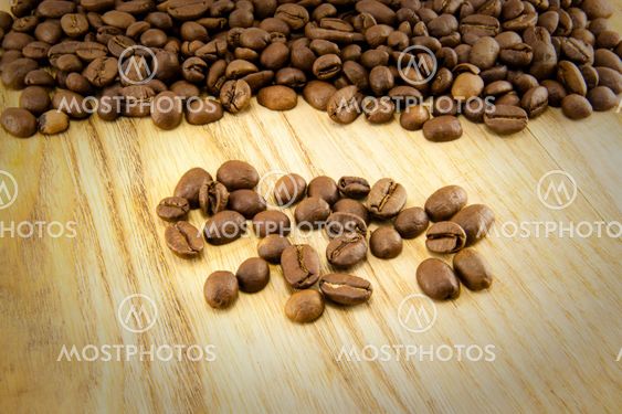 Coffee beans on vintage wooden board
