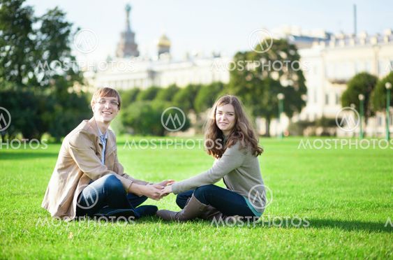 Happy couple sitting on the grass together