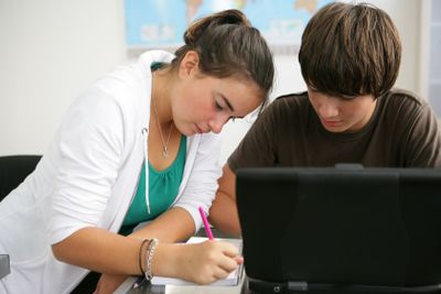 Teenagers studying in classroom