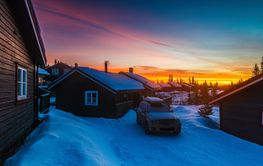 Stunning winter sunrise over a cozy cabin in Norway...