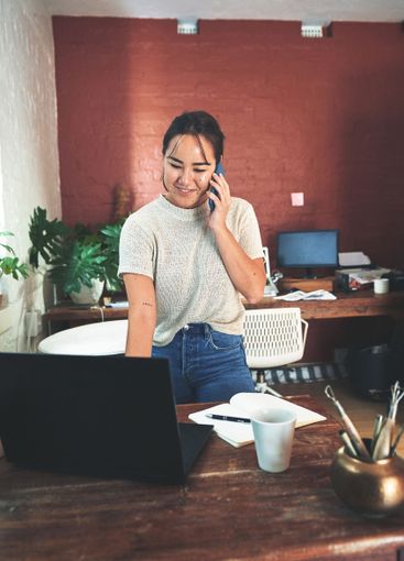 Happy, asian woman and laptop with phone call for small...
