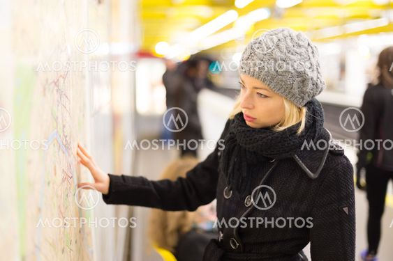 Lady looking on public transport map panel.