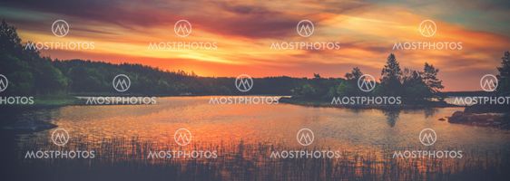 Vivid golden sunset in the archipelago of Scandinavia....