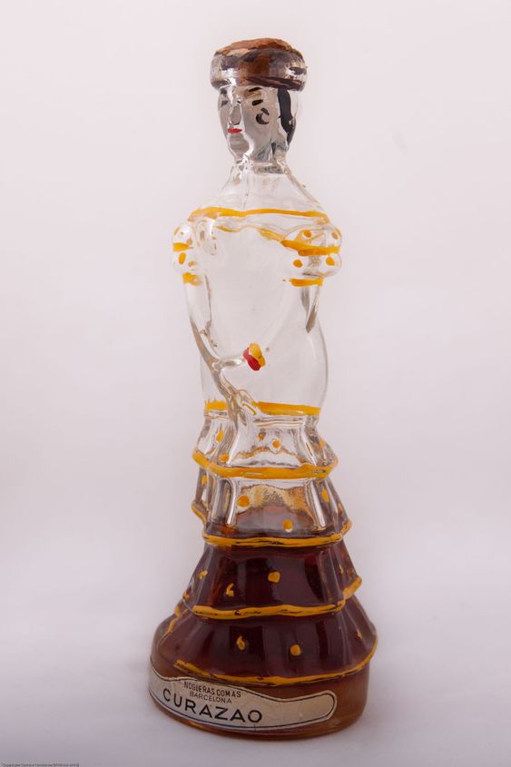 Half full bottle of liquor shaped like a woman