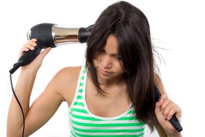 Teenager with hairdryer