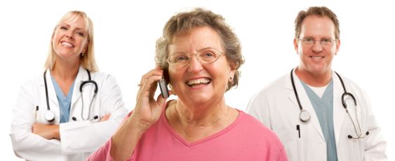 Happy Senior Woman Using Cell Phone and Doctors Behind