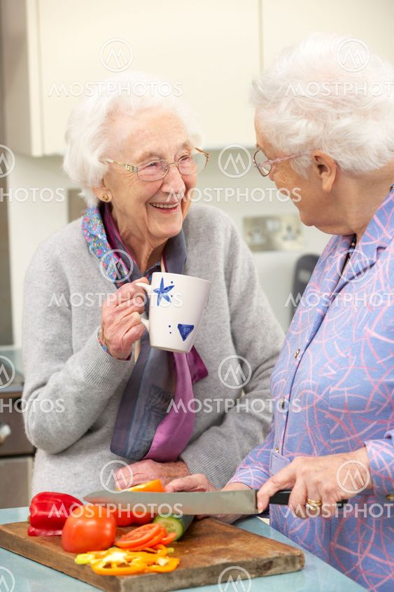 Senior women preparing meal together