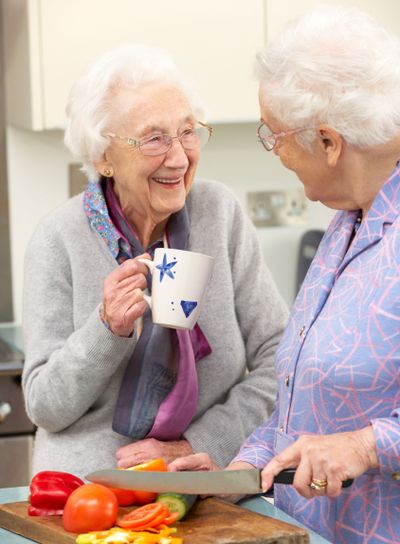 Senior women preparing meal together