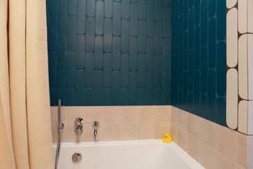 Close-up of a yellow rubber duck on the side of a clean...