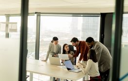 Team collaborates in modern office setting on innovative...