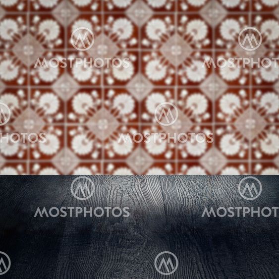 Wood table top and blur vintage ceramic tile pattern wall