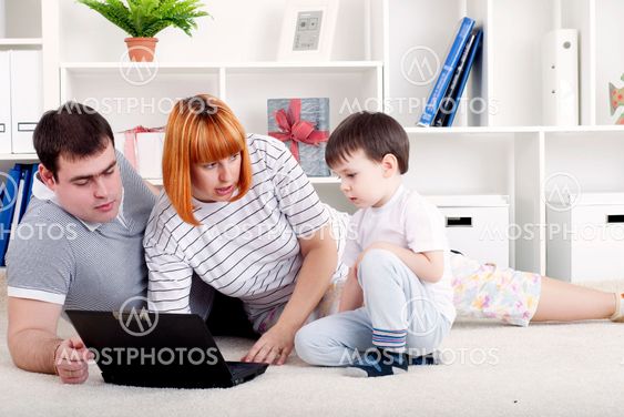 family looking at a laptop