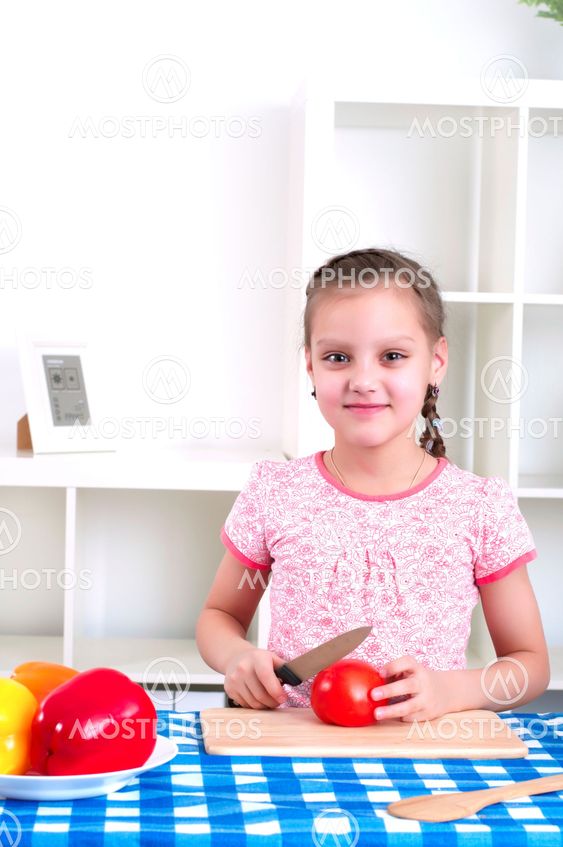 girl working in the kitchen cutting vegetables