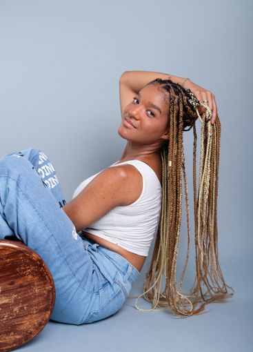 Beautiful brunette woman with braids in her hair,...