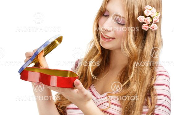 Beautiful young smiling woman with gift heart shape box