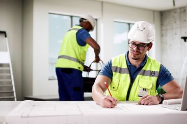 Professional foreman worker uses laptop to communicate