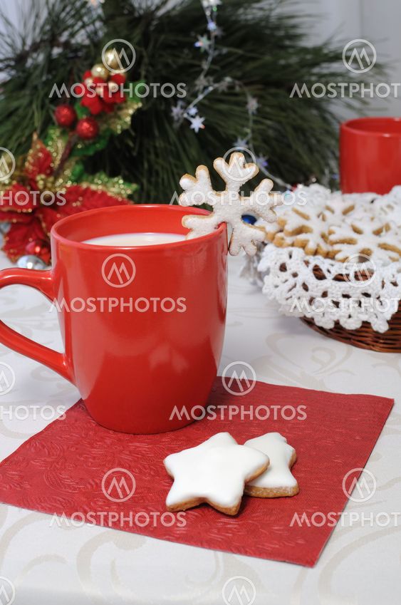 A cup of milk with sugar cookies in the glaze