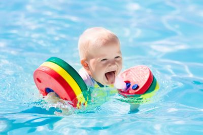 Little baby boy playing in swimming pool