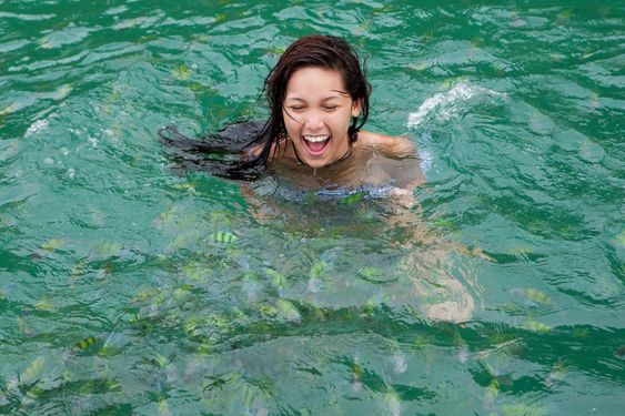 Girl swims with tropical fish