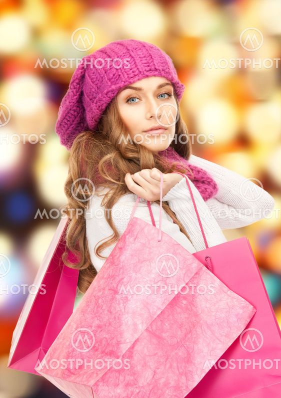 woman in winter clothes with pink shopping bags