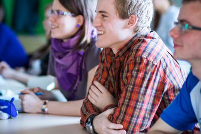 College students sitting in a classroom during class...