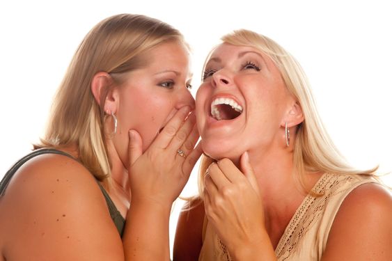 Two Blonde Woman Whispering Secrets
