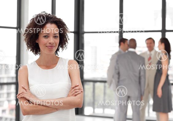 Afro Businesswoman arms folded with his colleagues
