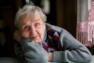 A soulful close-up portrait of an elderly woman