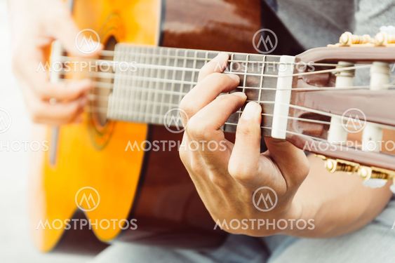 hand playing on guitar